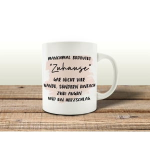 TASSE Kaffeetasse mit Spruch MANCHMAL BEDEUTET ZUHAUSE...